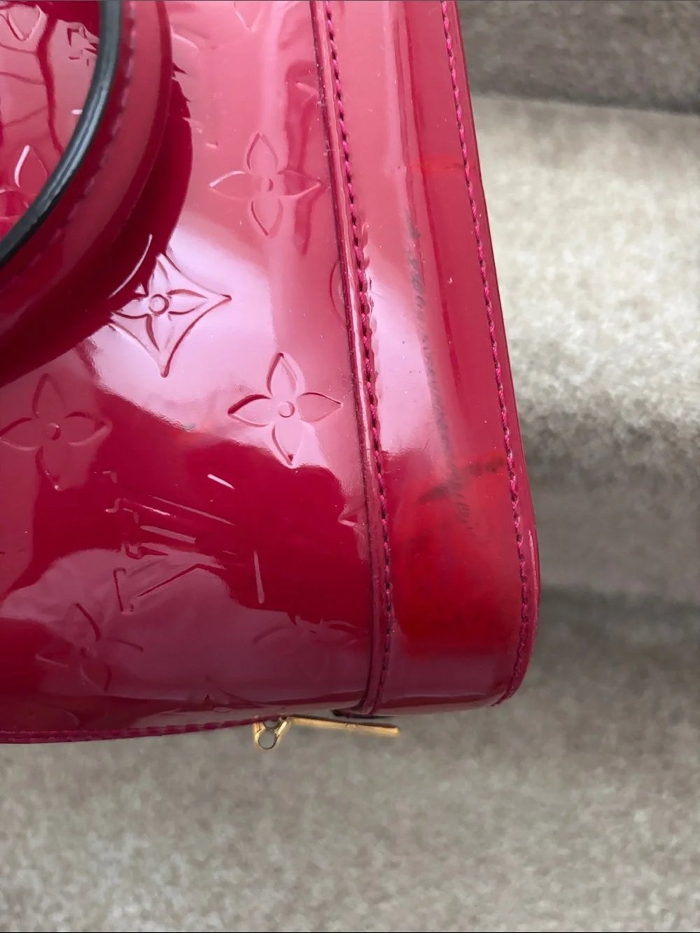 Red Louis Vuitton Alma BB crafted from glossy Monogram Vernis patent leather